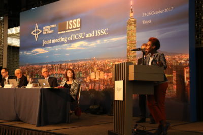 GYA Co-Chair Tolu Oni speaks at joing ICSU / ISSC meeting. Photo by Pichi Chuang